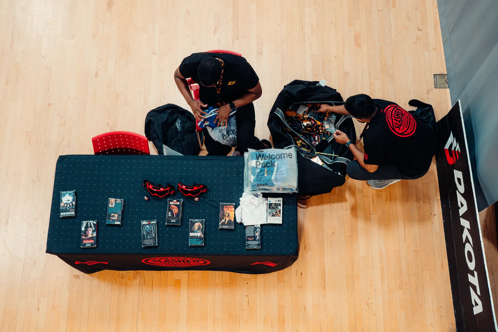 BRODIE staff setting up the scorer's table before a game night