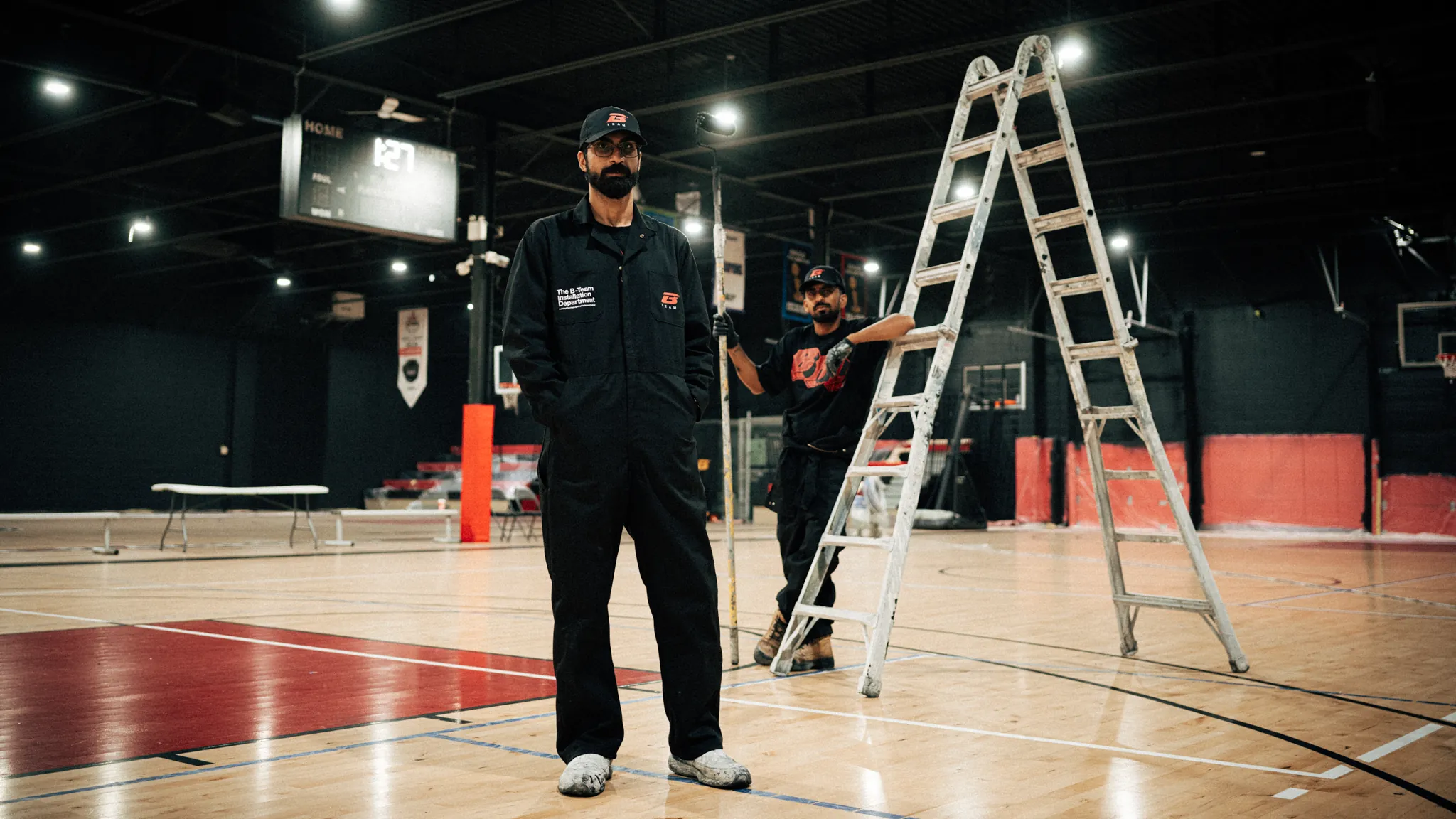 BRODIE crew member on a venue court during setup
