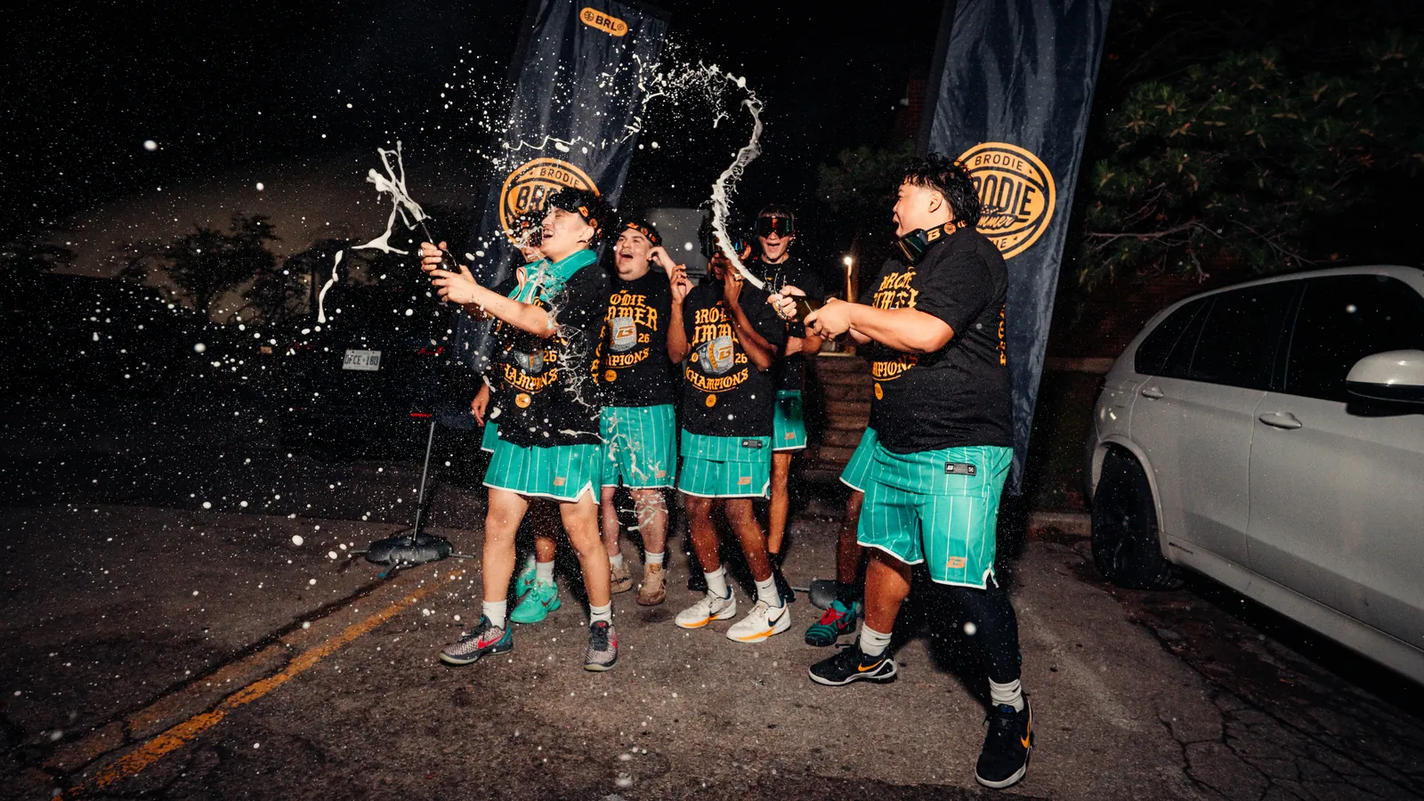 BRODIE champions spraying drinks after a playoff win