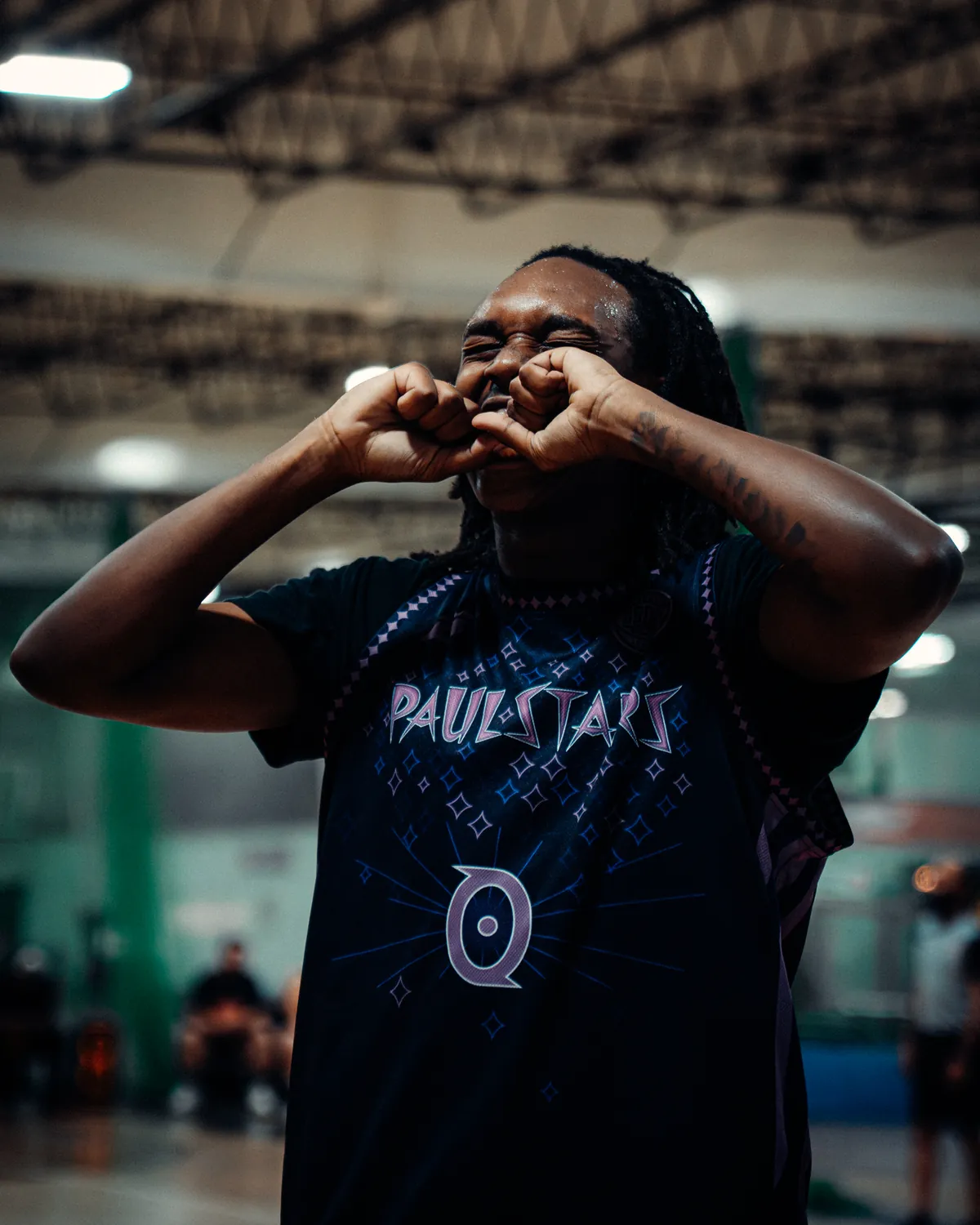 BRODIE athlete celebrating with both hands raised to his face