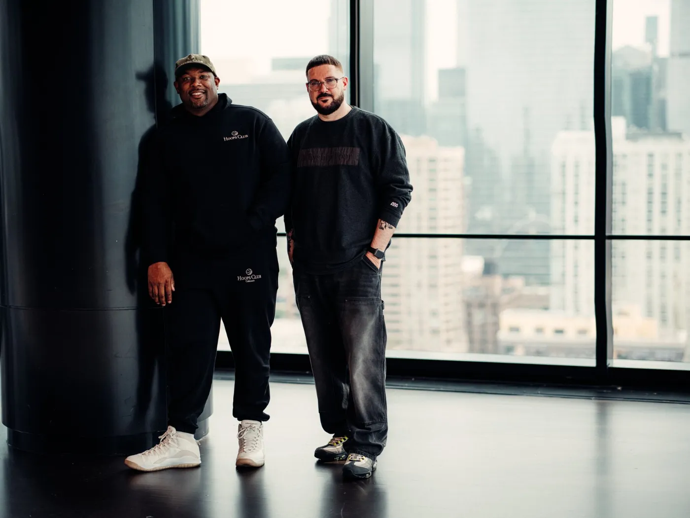 Two BRODIE city launchers standing in a glass-walled gym above the skyline