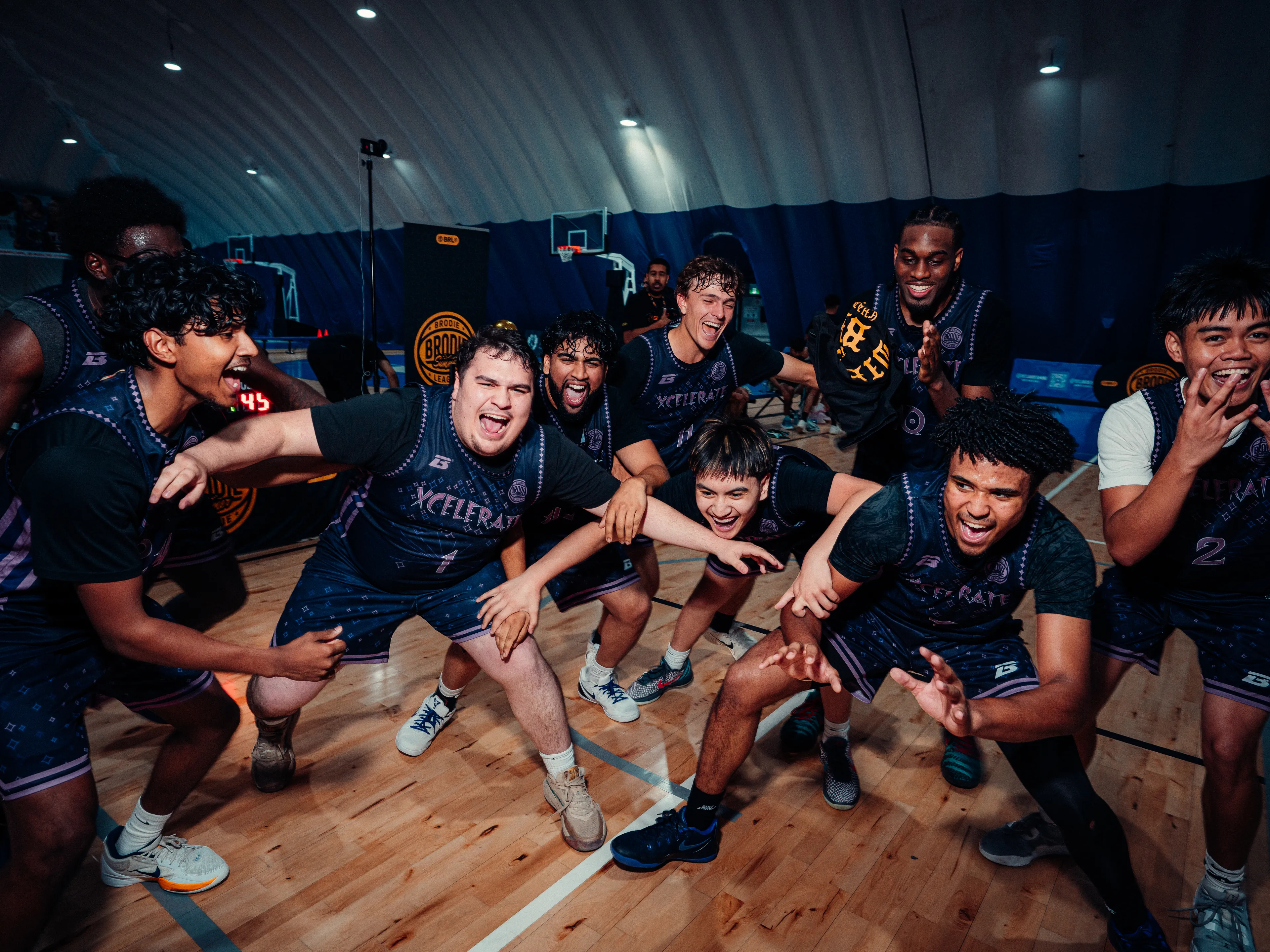 A BRODIE® team celebrating together on court after a playoff win