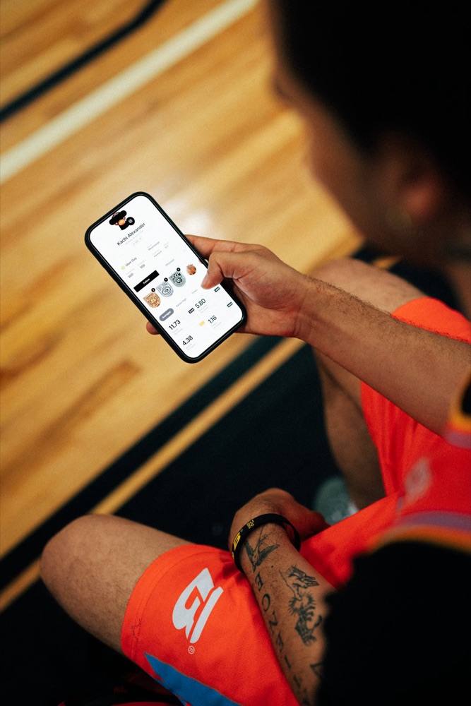 Player checking the Brodie App courtside