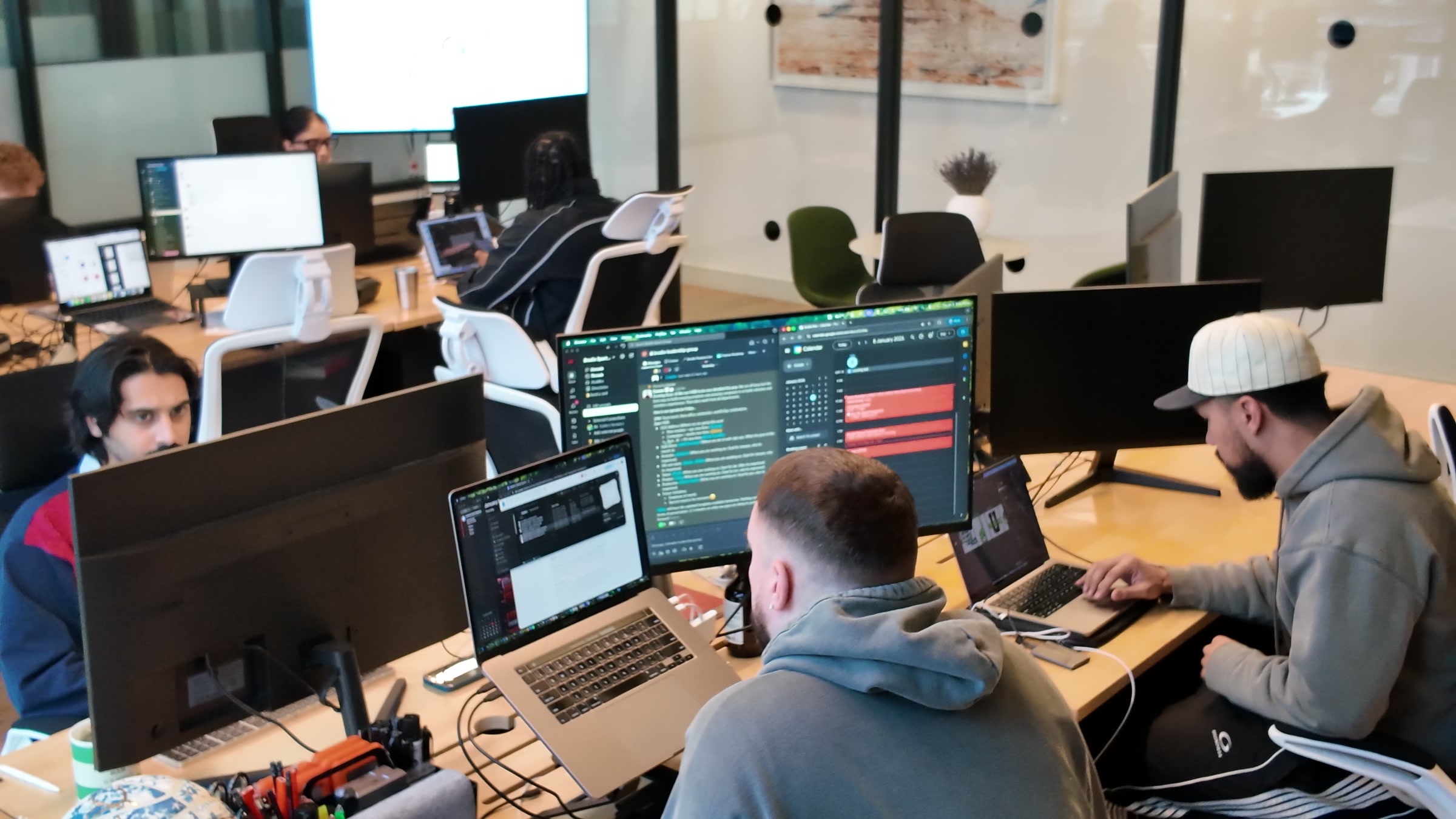 Brodie team working at desks with multiple monitors