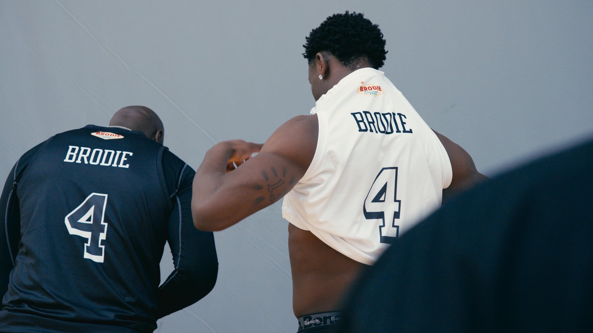 Two Brodie athletes seen from behind in number 4 jerseys