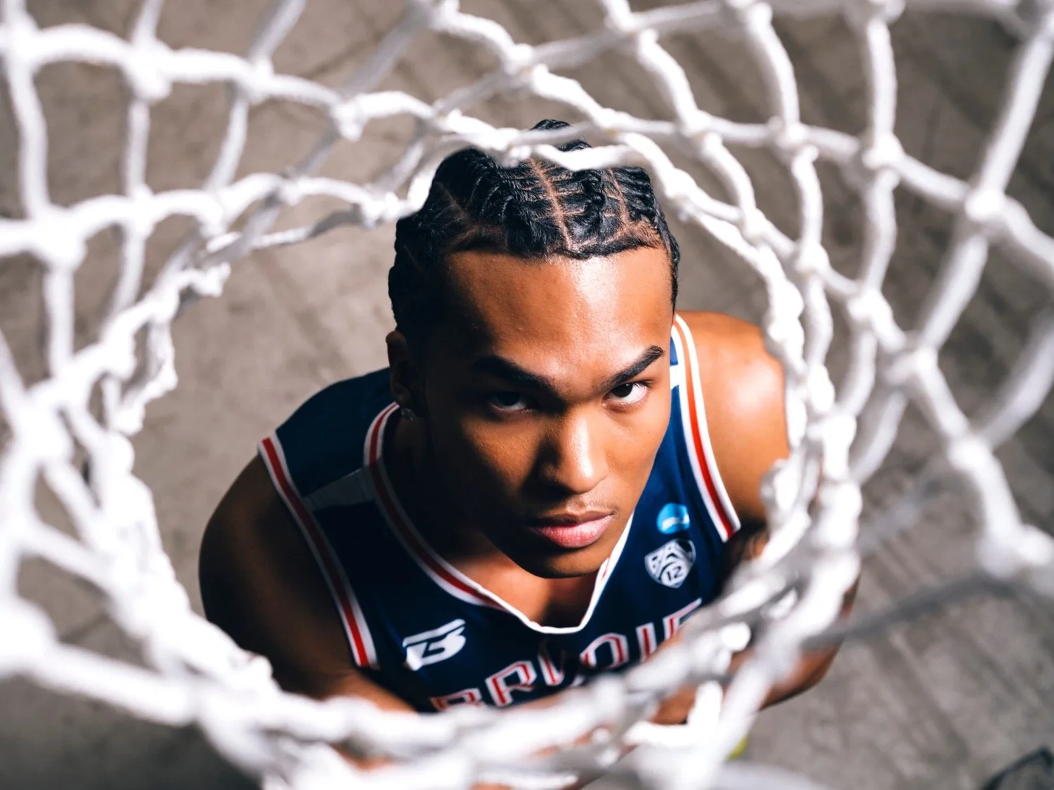 Athlete looking up through a basketball net