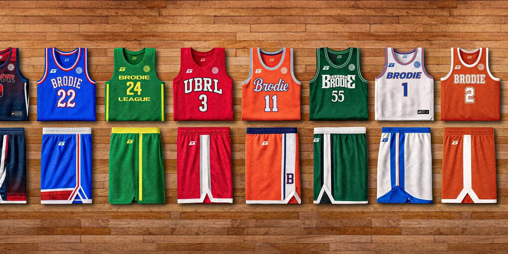 Row of Spring ’26 jerseys and shorts laid out on a hardwood floor