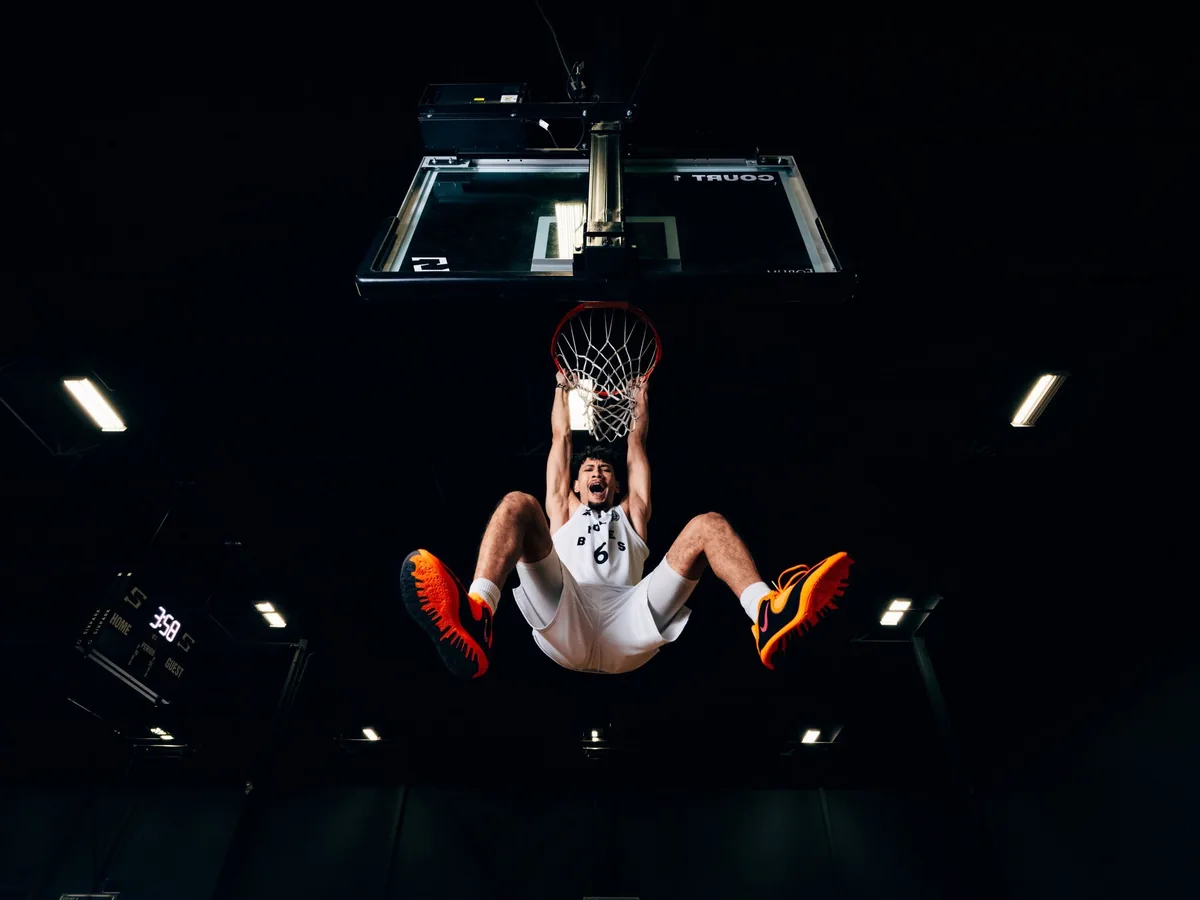 A player hanging from the rim after a dunk