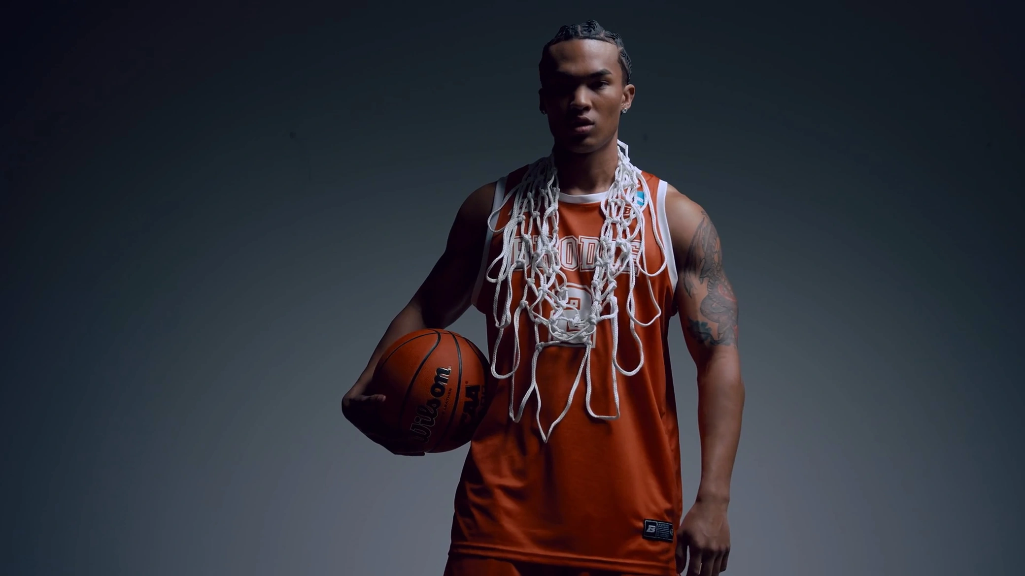 Bracket Season athlete in an orange jersey with a cut basketball net around his neck