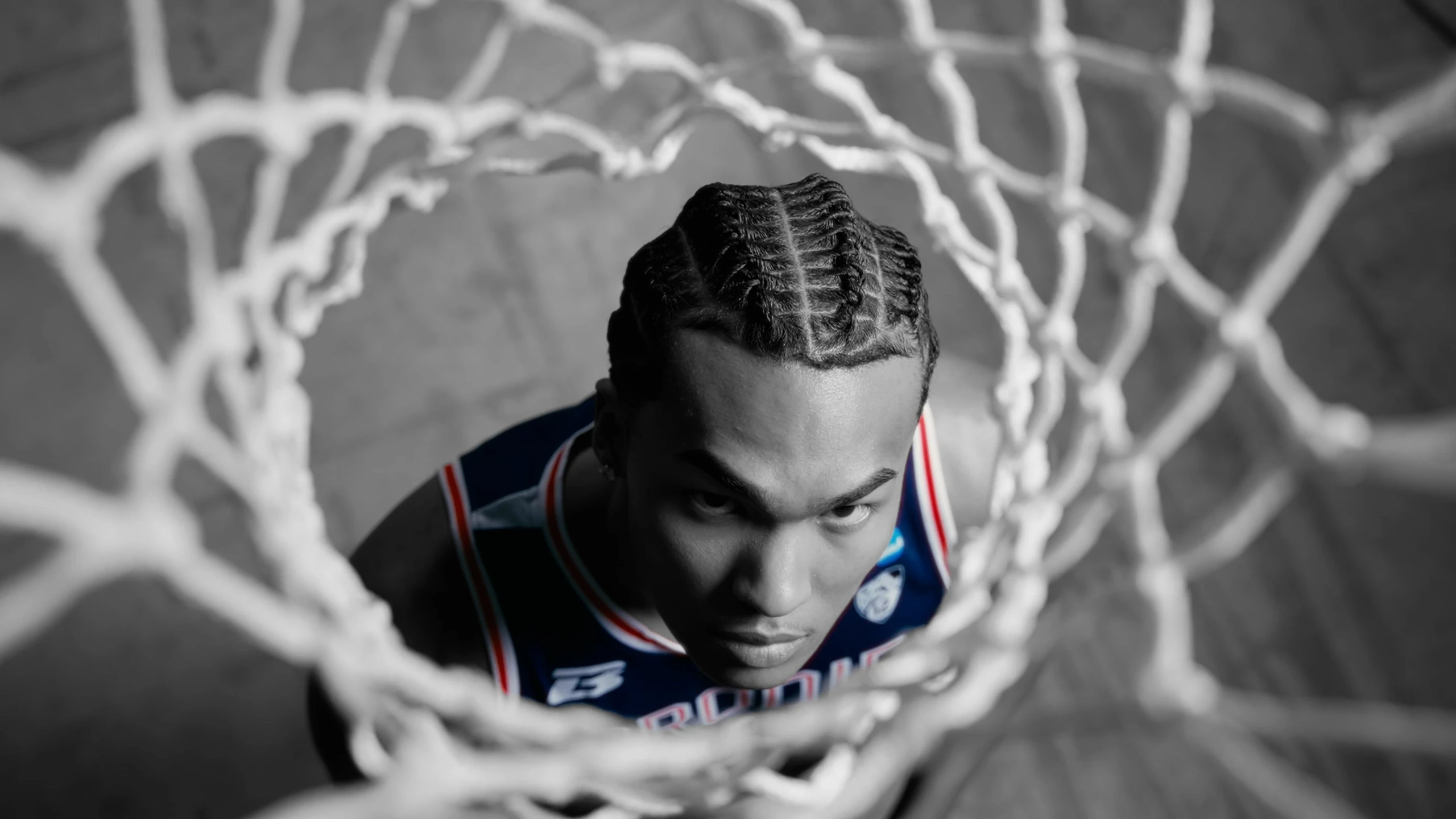 Bracket Season athlete looking up through a basketball net
