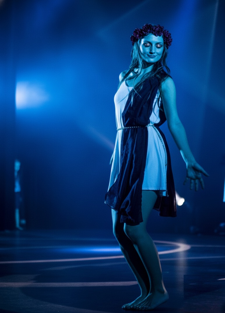a dance instructor leading a class in a sunlit studio