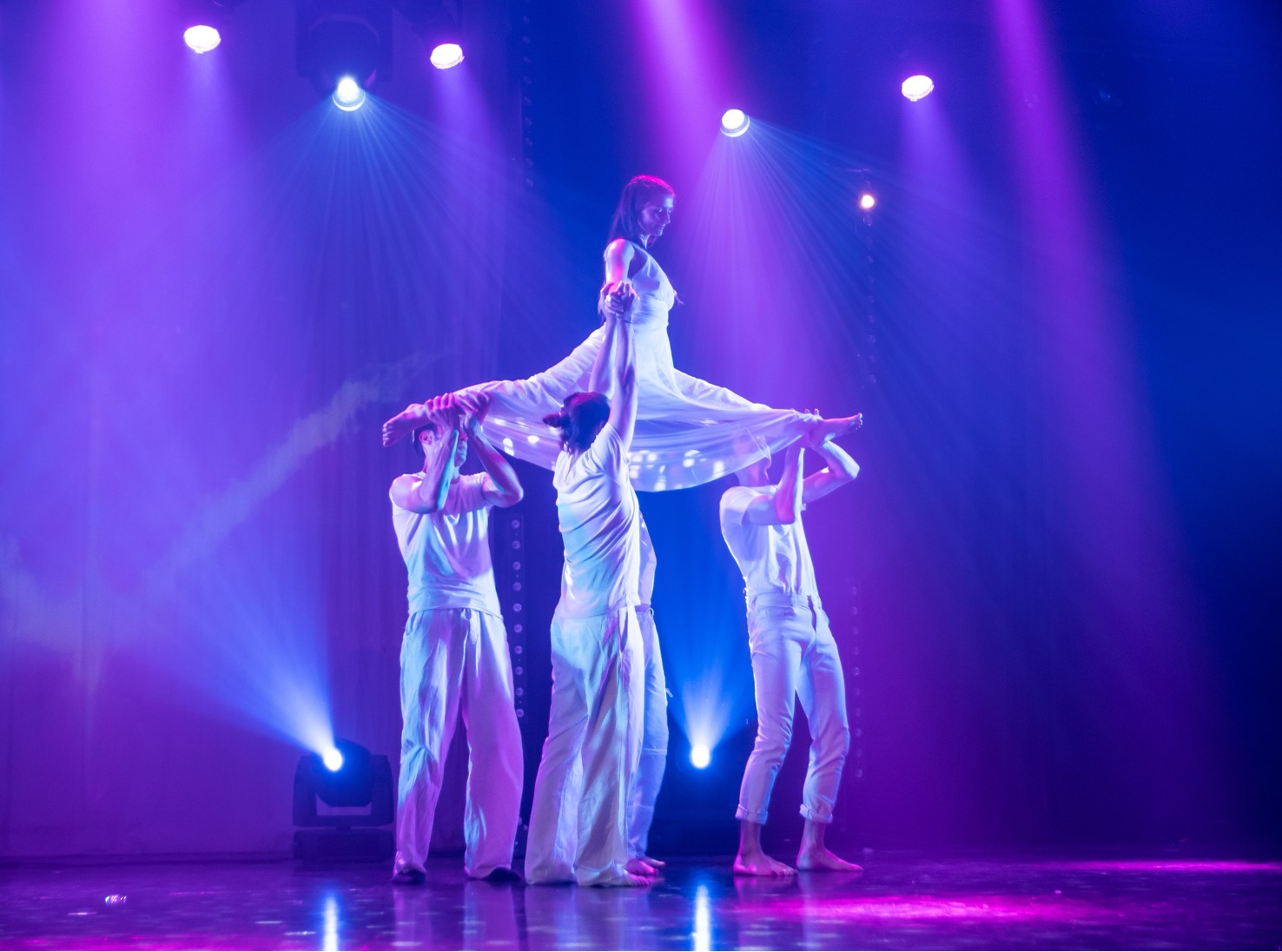 image of a dance instructor guiding a class in a dance studio