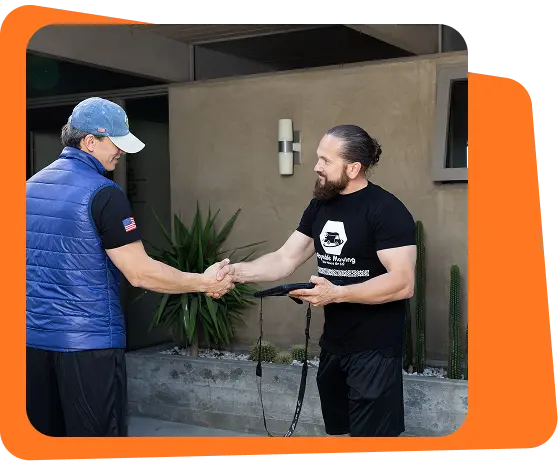 Payable Moving Company mover shaking hands with a customer outside a home