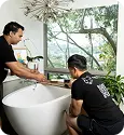Payable Moving Company team handling a freestanding bathtub during a careful home relocation.