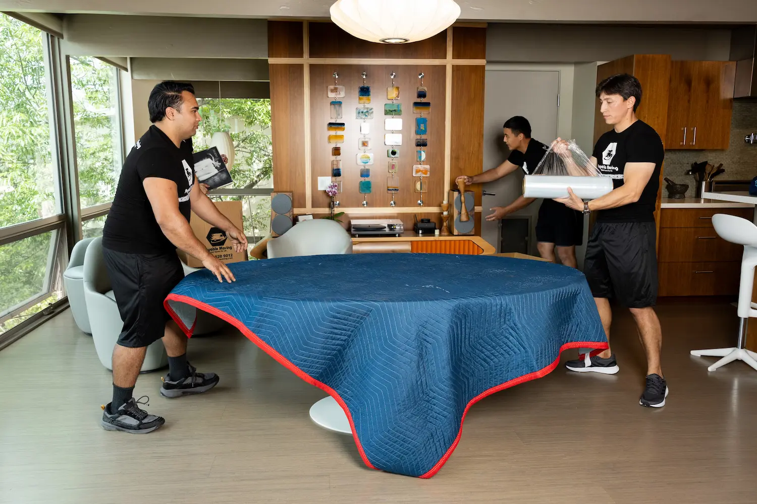 Moving professionals packing household items securely