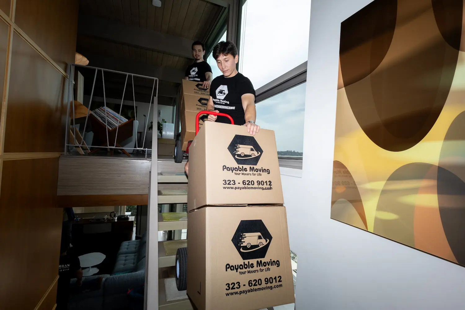 Home relocation with movers carrying boxes and furniture