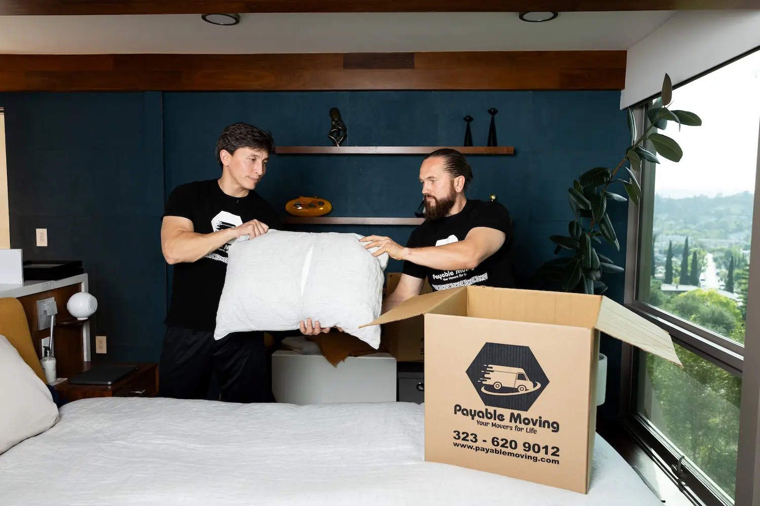 Movers carefully lifting heavy furniture during a local move