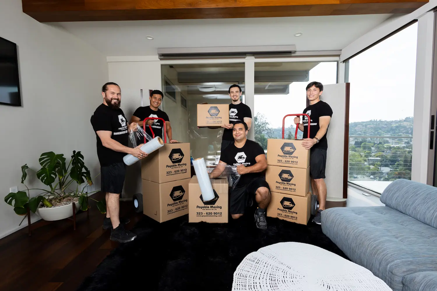 Experienced movers organizing furniture inside a moving truck