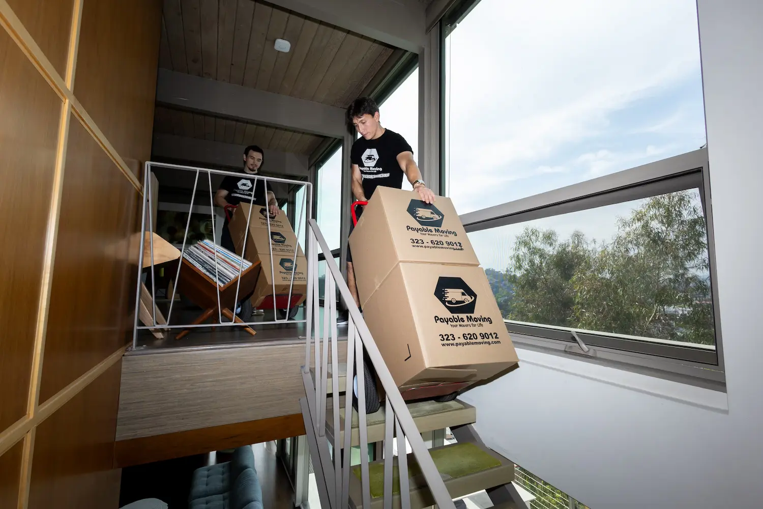 Professional movers carefully loading furniture into a moving truck