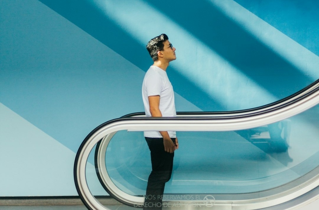 A person in an elevator rising upward, symbolizing progress and business growth