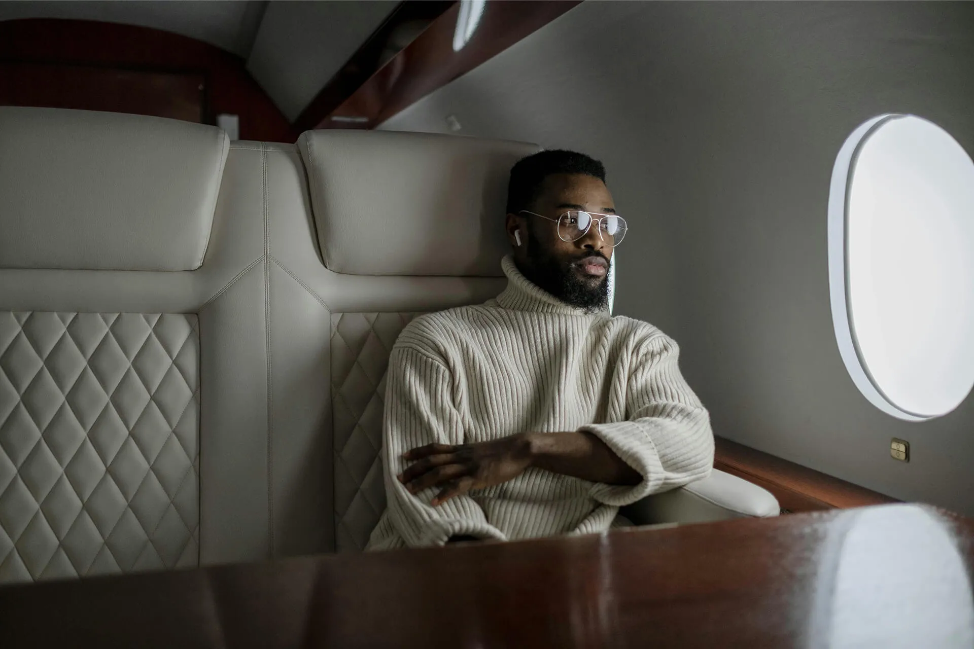 man in white sweater wearing eyeglasses