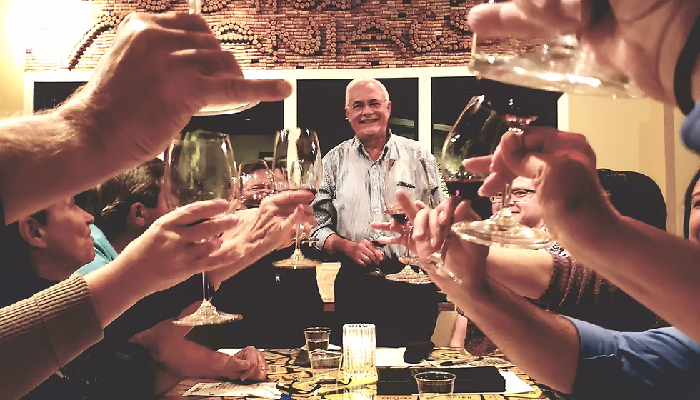 Wine Maniacs founders and friends raising glasses around a table