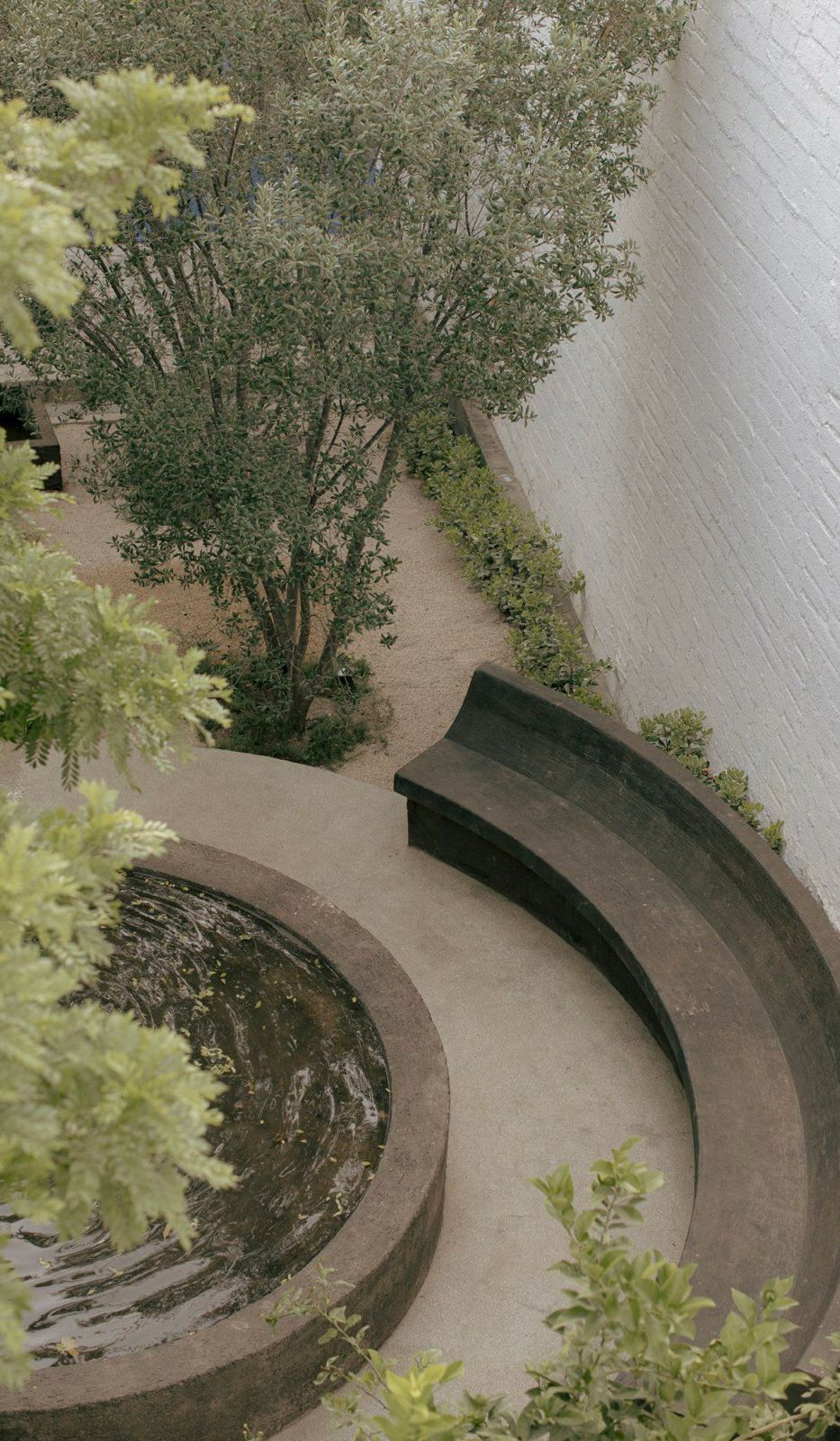 Young woman sleeping peacefully on her side under dark blue sheets.