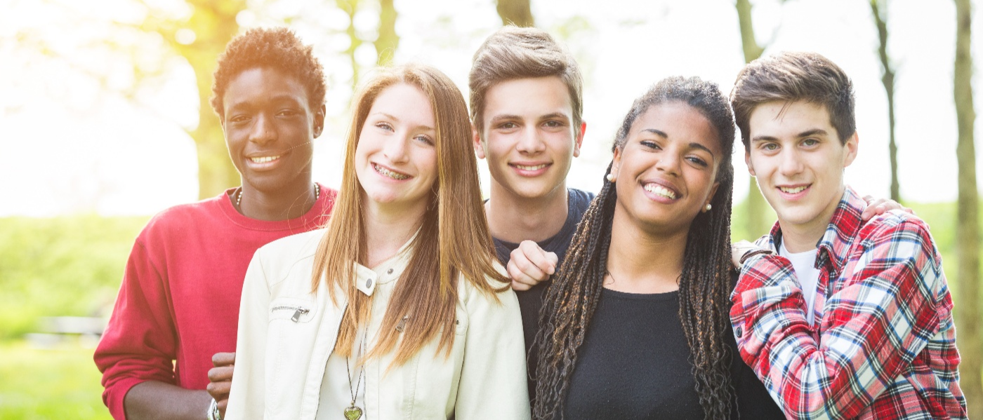 A group of 5 smiling people