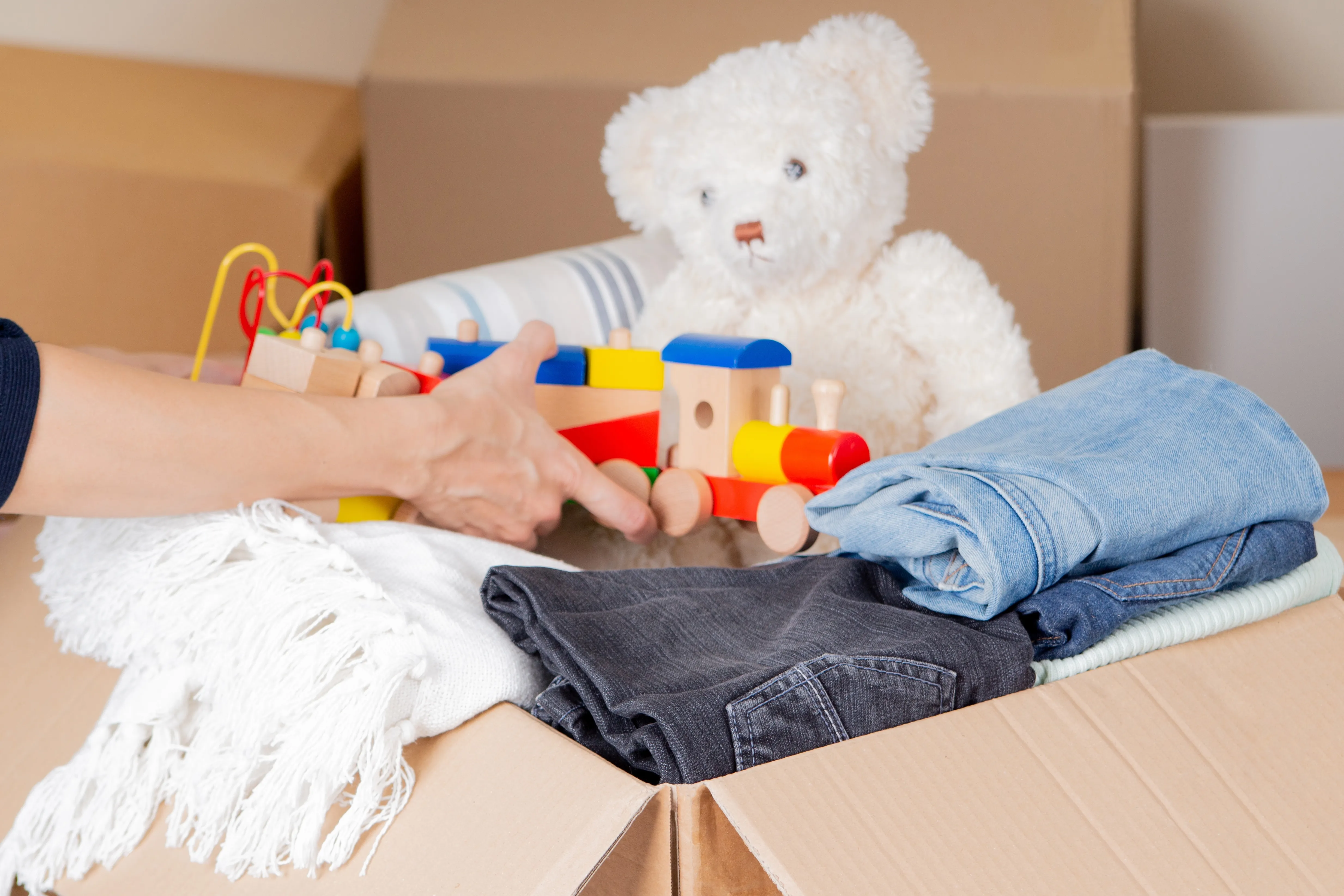 Box filled with clothing and toys