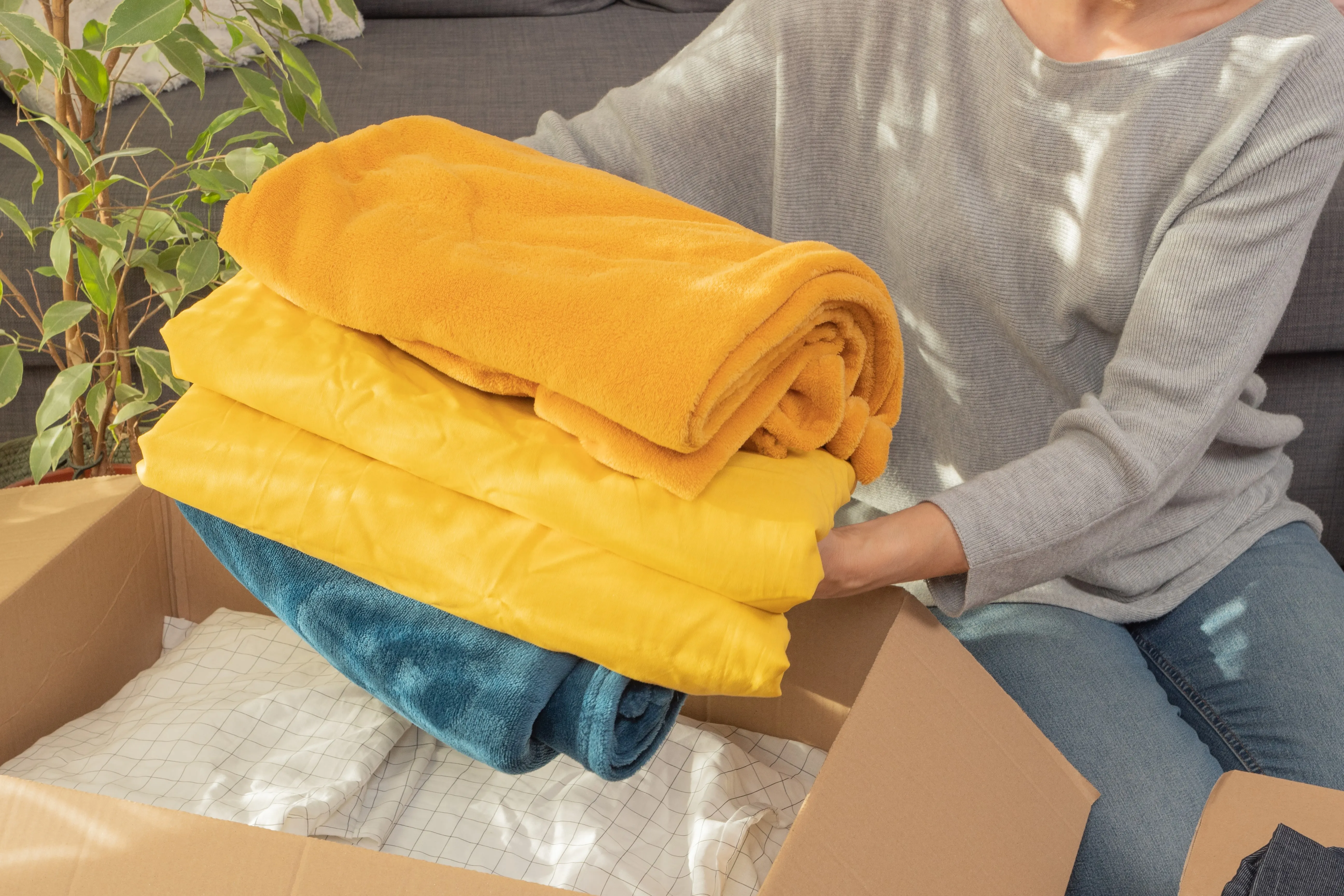 Person filling box with towels