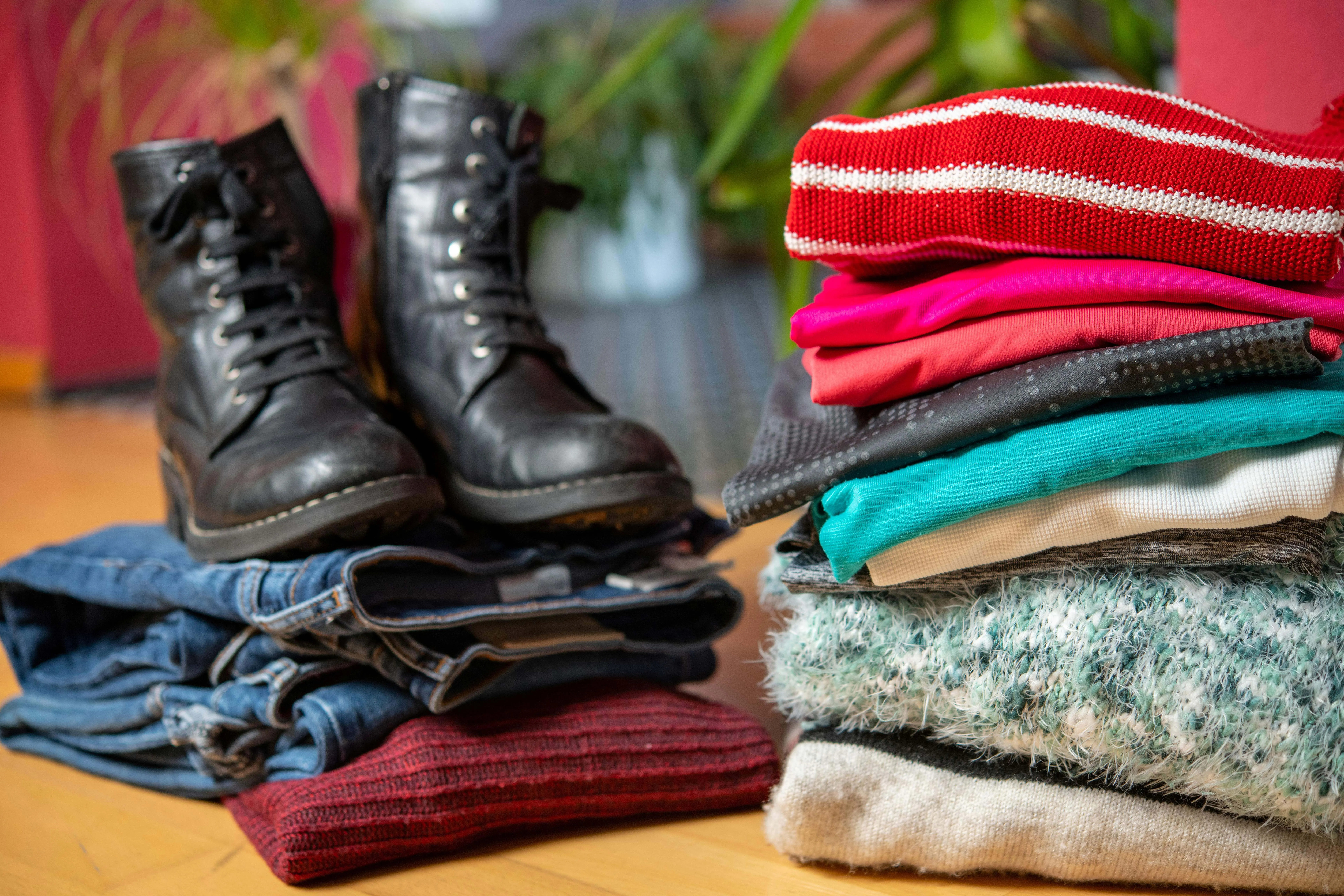 A stack of clothes with boots on top