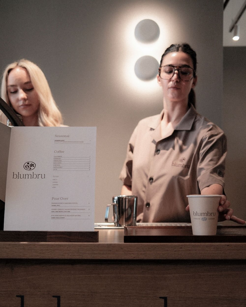 Barista working behind mobile coffee catering bar.