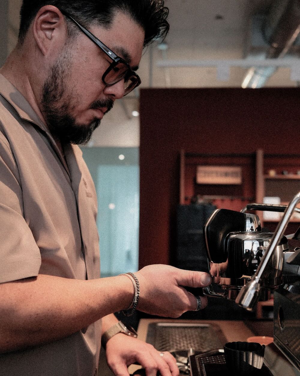 Barista working extracting espresso shot.