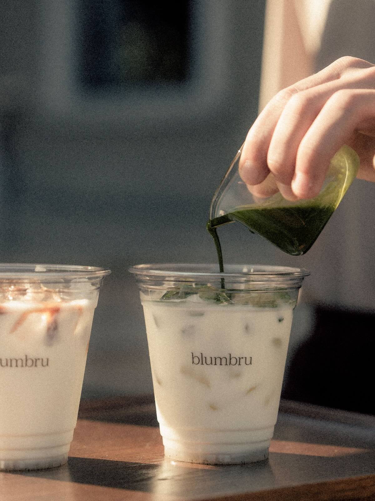 Matcha being poured into milk.