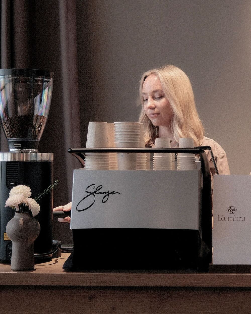 Barista working behind espresso bar.