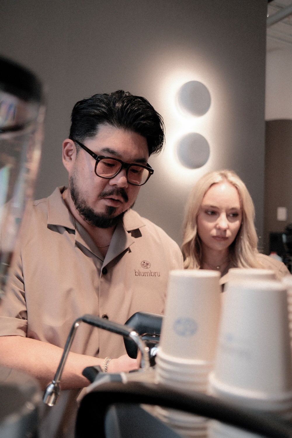 Coffee caterer working behind a coffee bar at an event.