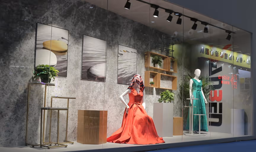 Crowd of people exploring a futuristic space technology exhibit with large screens showing planets and a rocket model.