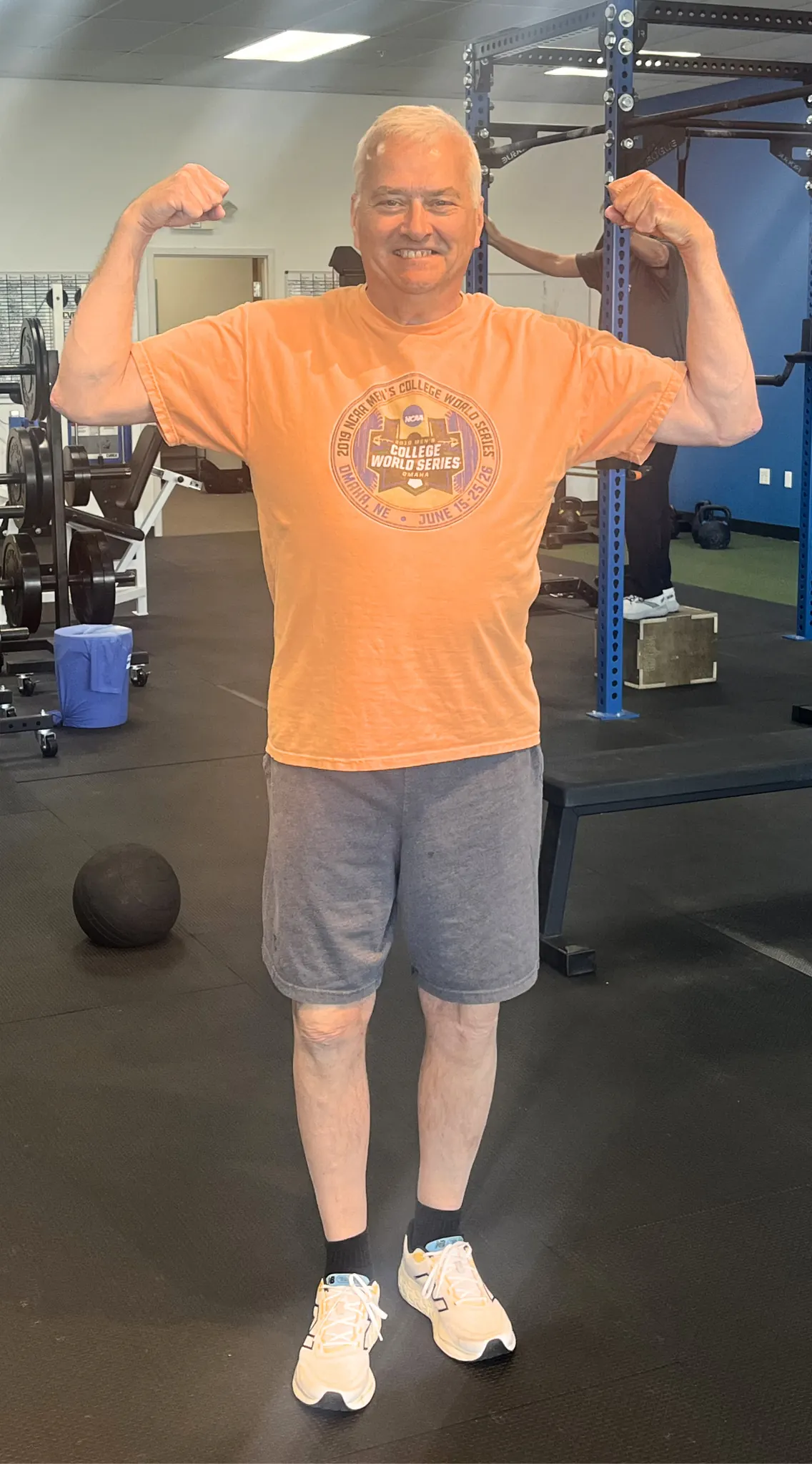 David, a 66-year-old Adamo member, flexing in the gym