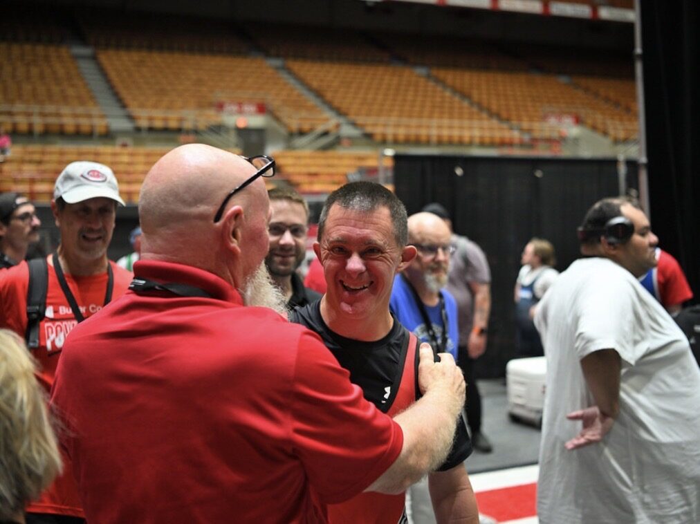 Coaches and athletes together at a powerlifting competition