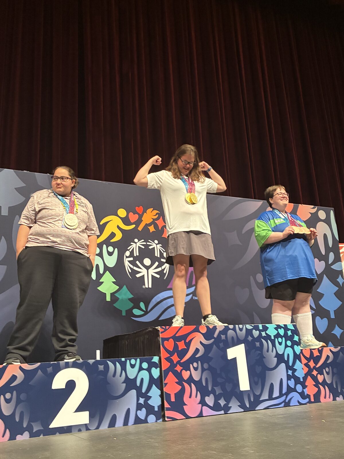 An athlete celebrating on the first place podium