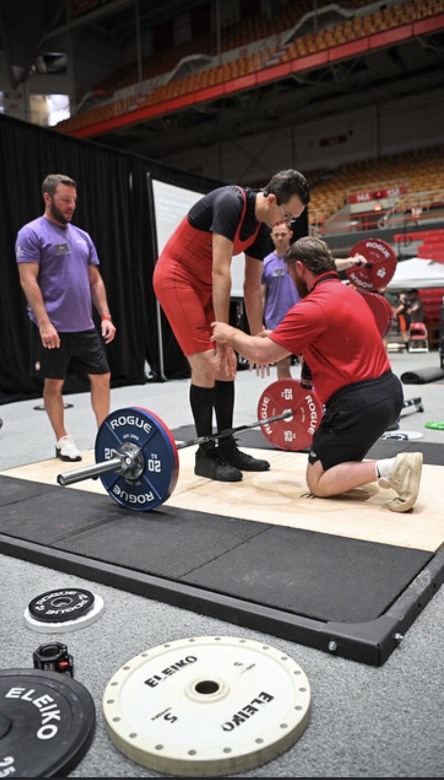 A coach supporting an athlete on the competition platform
