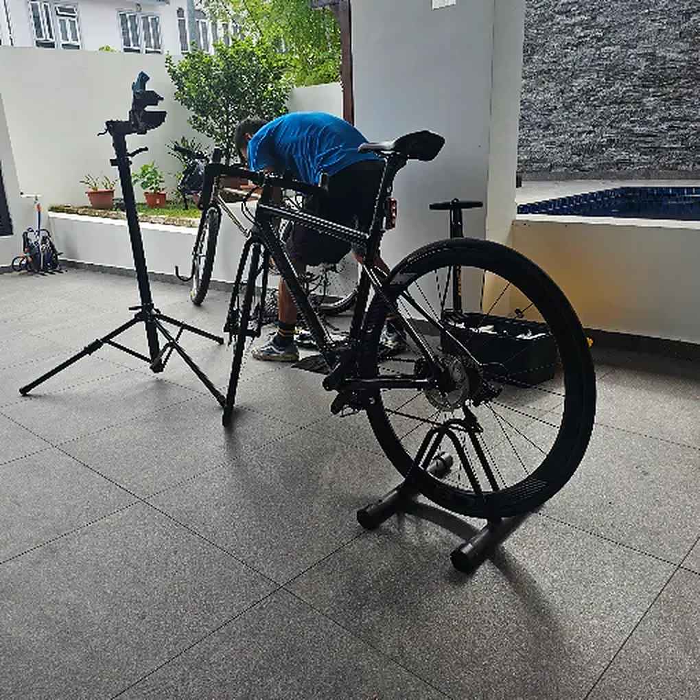 Road bike on a Bike Hero work stand at a customer's porch