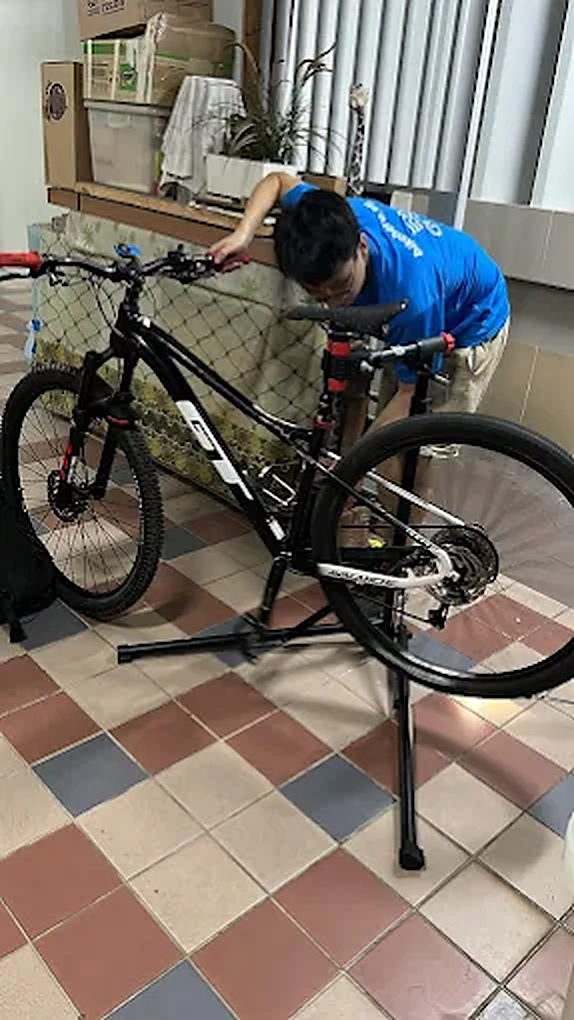 Mountain bike on a work stand being serviced by a Bike Hero mechanic