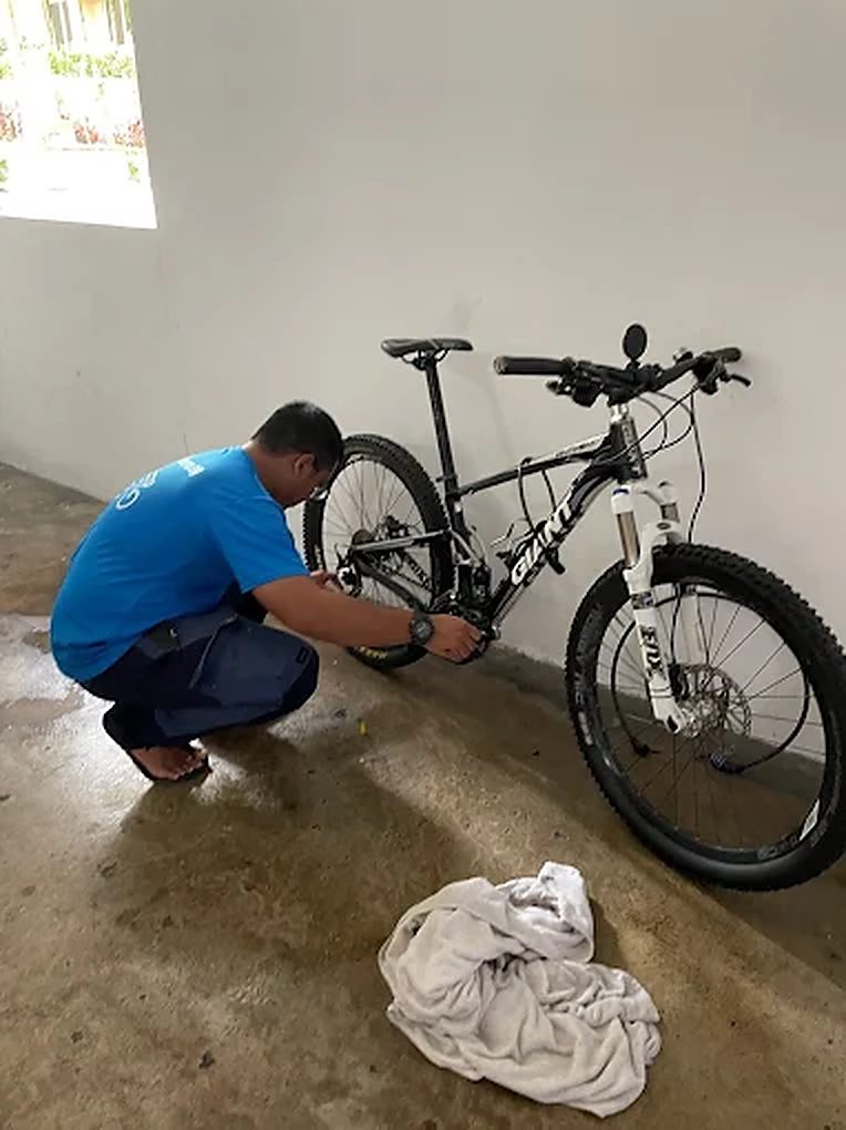 Bike Hero mechanic servicing a mountain bike at a customer's block
