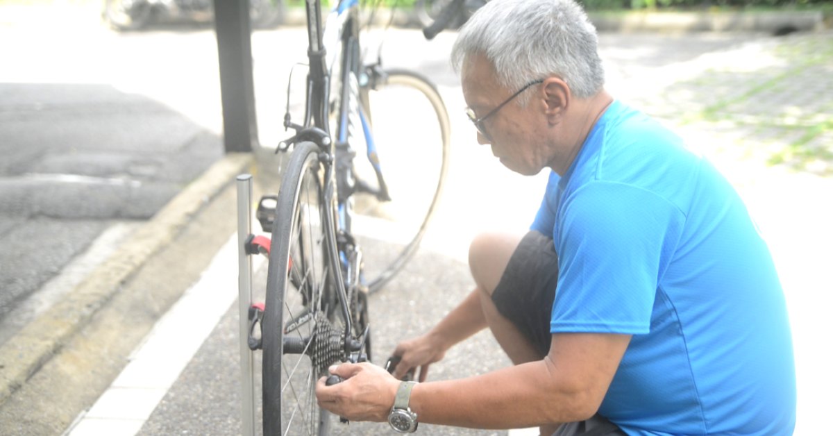 Bike Hero mechanic servicing a bicycle at the kerb outside a customer's home