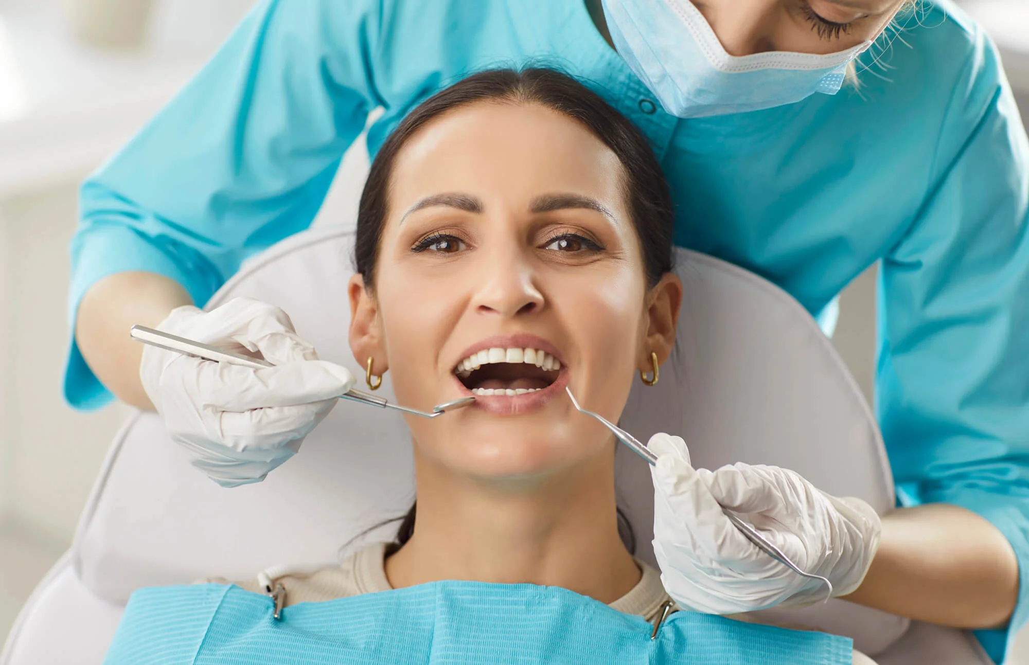 A dentist near you examining after placement of dental implants.