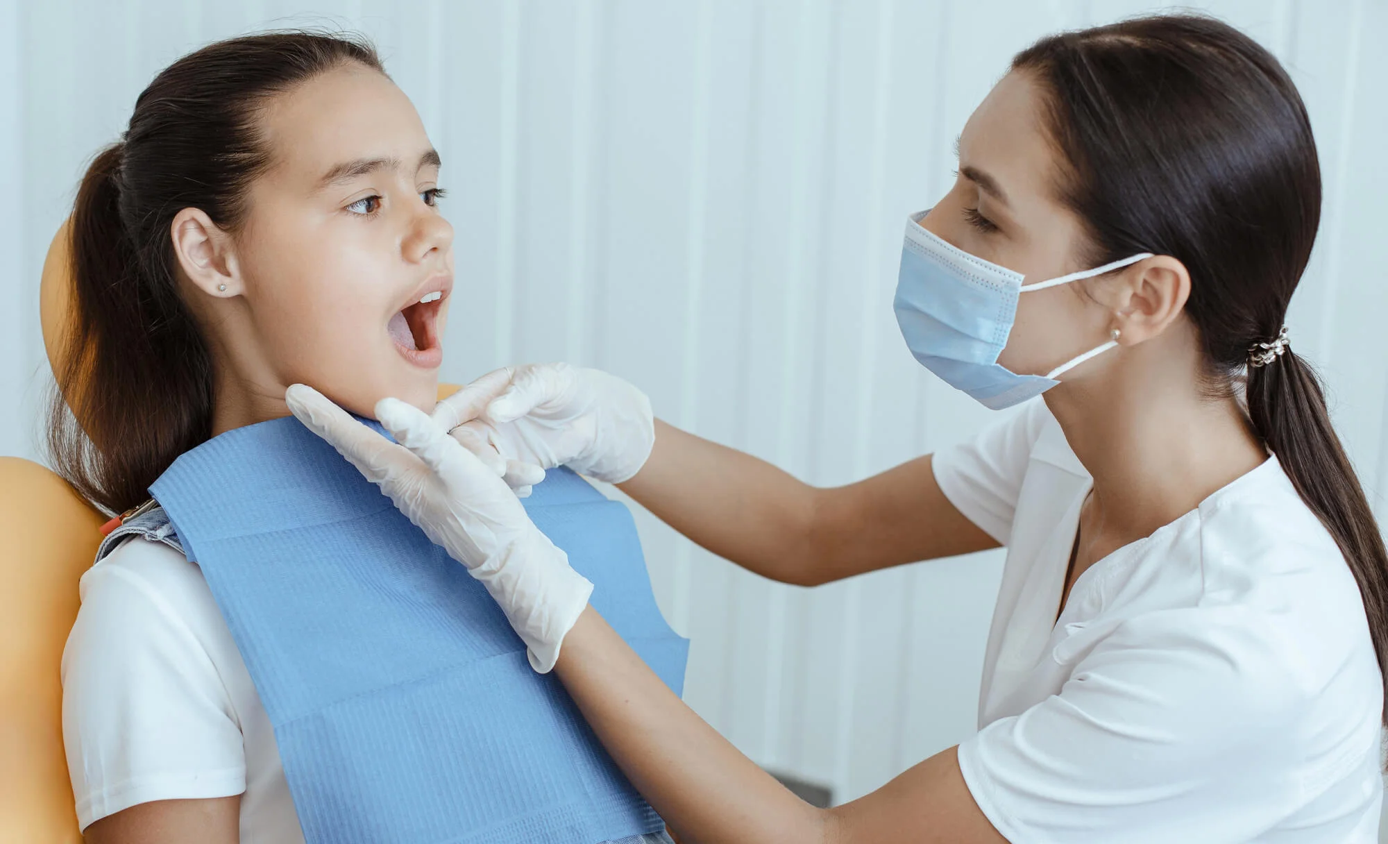 Dentist examines patient for Invisalign treatment in Springfield, PA.