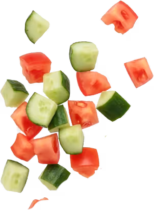 Chunks of fresh cucumber and tomato scattered on a white background.