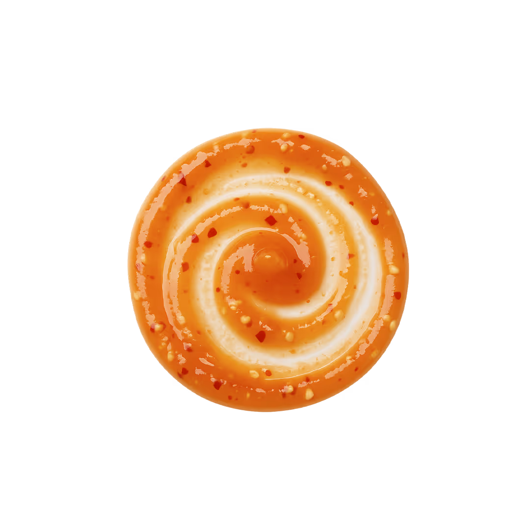 Swirl of orange hot honey sauce with red chili flakes on a white background.