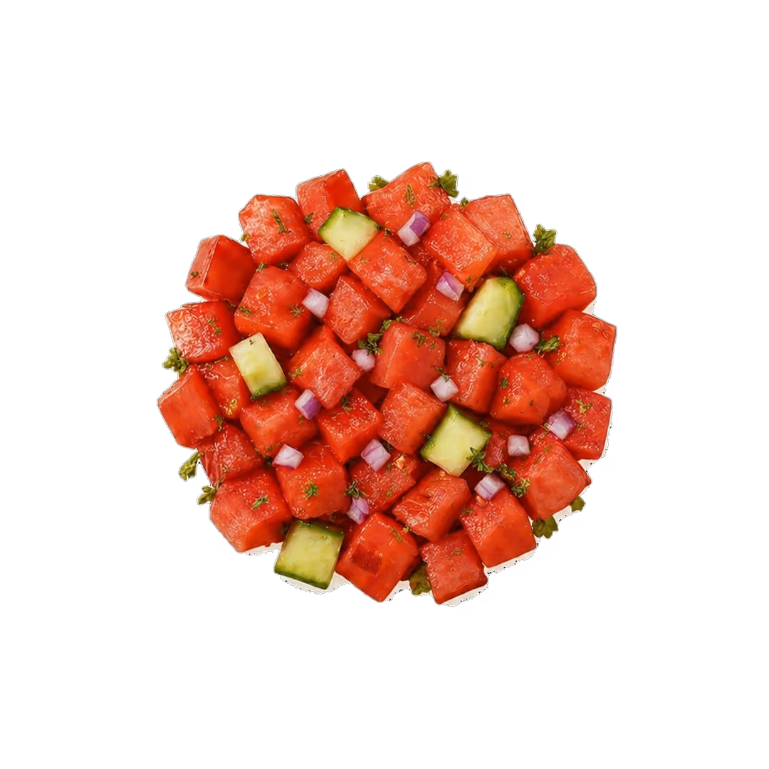 Diced watermelon and cucumber cubes garnished with small green herbs on a white background.